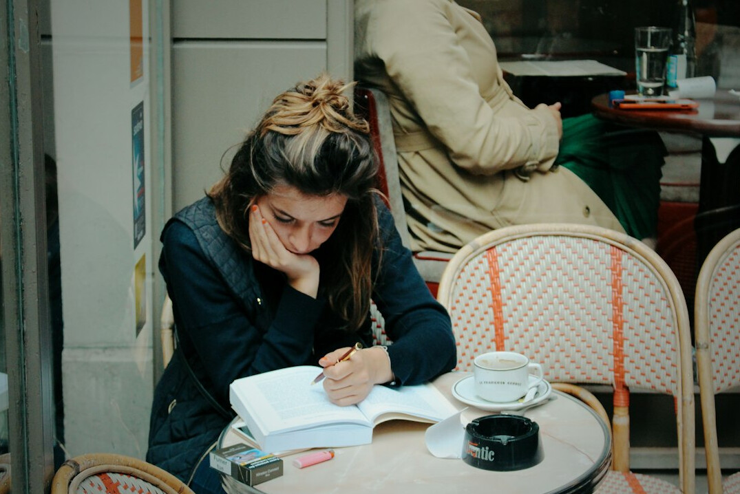 writer observing people in cafe